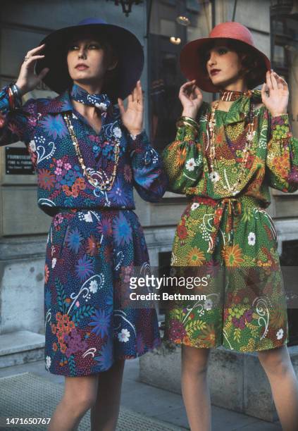 Two models pose in floral-print silk crepe dresses from French designer Guy Laroche's spring/summer collection in Paris, France, on February 1st,...
