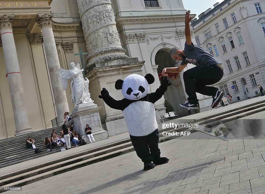 A woman dressed up as a panda gestures a