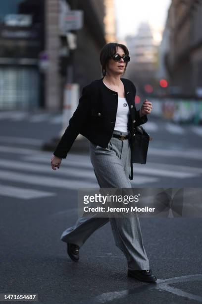 Patricia Wirschke seen wearing Celine brown Triomphe sunglasses, Loewe white logo top, Hermès Kelly black leather bag, Rossi grey striped wide leg...