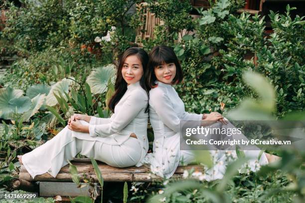 beautiful young lady with conical hat in ao dai dress - tet stock pictures, royalty-free photos & images