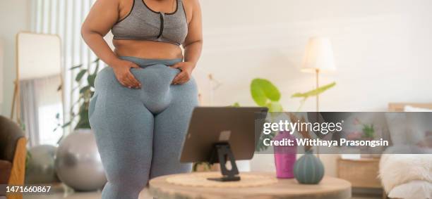 cropped shot of an unrecognizable woman struggling with weight issues - pinching stock pictures, royalty-free photos & images