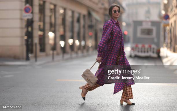 Patricia Wirschke seen wearing Ray-Ban gold round sunglasses, Odeeh purple / pink heart print pattern button maxi silk dress with long sleeves, Odeeh...