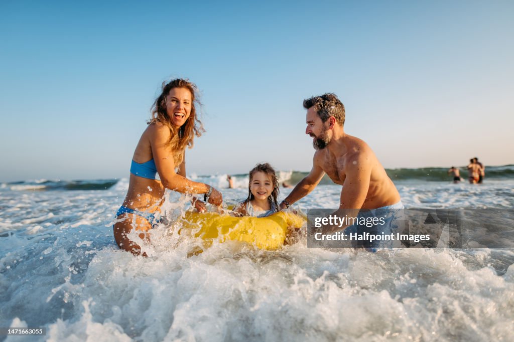 Young family enjoying time at sea.