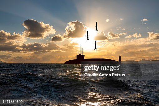 Submarine missile launch. Nuclear submarine at sea at sunset. Submarine missile launch. Nuclear submarine at sea at sunset.