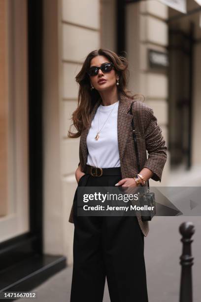 Füsun Lindner seen wearing Arket brown / black checked blazer jacket, COS white cotton t-shirt, COS black wide leg pants, Ole Lynggaard gold elephant...