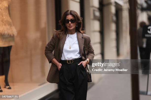 Füsun Lindner seen wearing Arket brown / black checked blazer jacket, black sunglasses, COS white cotton t-shirt, COS black wide leg pants, Ole...