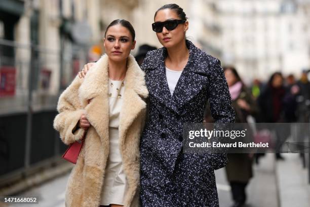 Guest wears a white matte short dress with embroidered silver and yellow stones pattern, a beige sheep long coat, a red pale shiny leather shoulder...