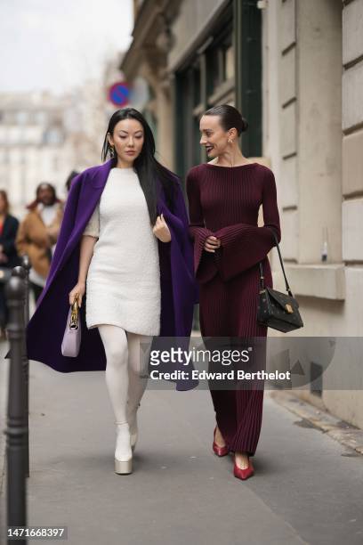 Guest wears a neon purple long coat, a white wool short sleeves short tube dress, a pale purple matte leather with gold handle handbag from Lanvin,...