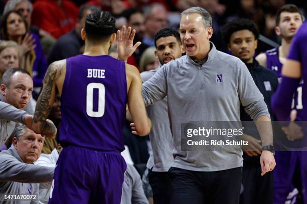 Head coach Chris Collins of the Northwestern Wildcats high fives Boo Buie during a game against the Rutgers Scarlet Knights at Jersey Mike's Arena on...