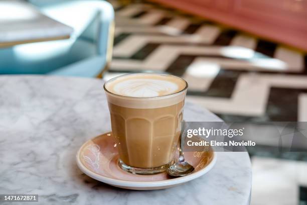 cappuccino coffee with latte art on white soy milk foam on a marble table in a coffee shop - latte art ストックフォトと画像