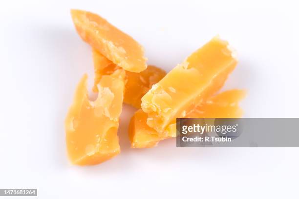 piece of old hardcheese on a white background isolated - cheddar kaas stockfoto's en -beelden