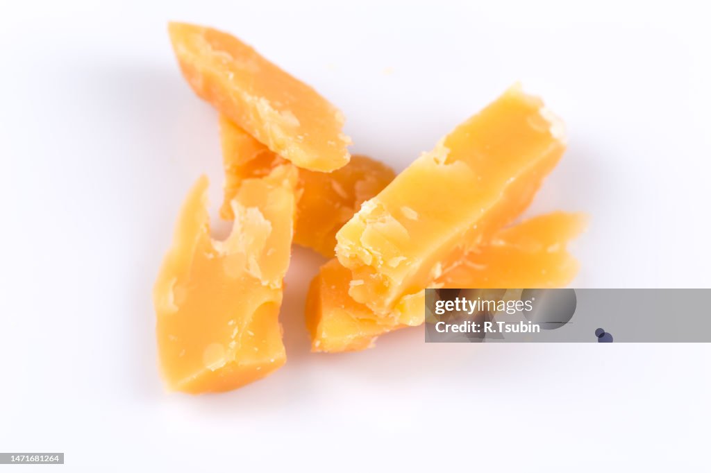 Piece of old hardcheese on a white background isolated