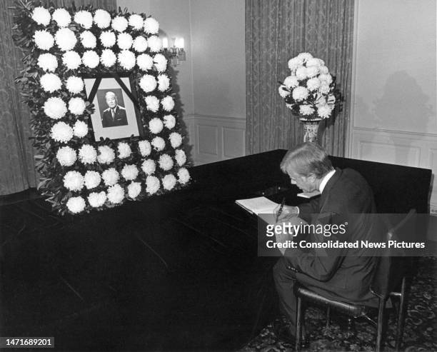 President Jimmy Carter signs a condolence book as he pays his respects at a memorial for Japan's Prime Minister Masayoshi Ohira at the Japanese...