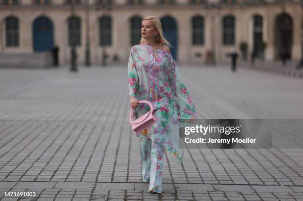 Palina Kozyrava seen wearing Natkina diamond flower earrings and diamond rings, Leonard light blue with pink flower print pattern asymmetrical...