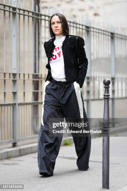 Guest wears a white with red "Love" slogan print pattern turtleneck t-shirt, a black suede zipper jacket, black with white latte print pattern large...