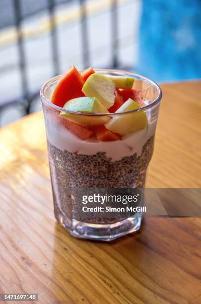 chia parfait with yogurt and sliced fruit (apple and papaya) - fruit parfait stock pictures, royalty-free photos & images