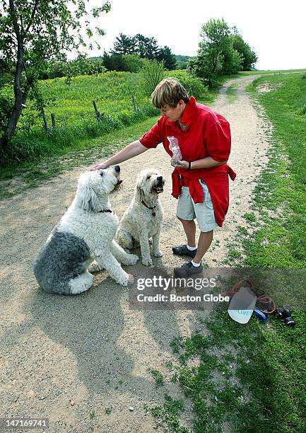 Woodsom Farm - Ghlee Woodworth stops to offer treats and water to Oliver, left, an English sheep dog, and Oliver, right, a golden doodle. The dogs...