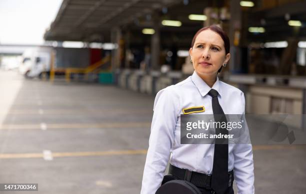 female security guard working at a distribution warehouse - security guard stock pictures, royalty-free photos & images