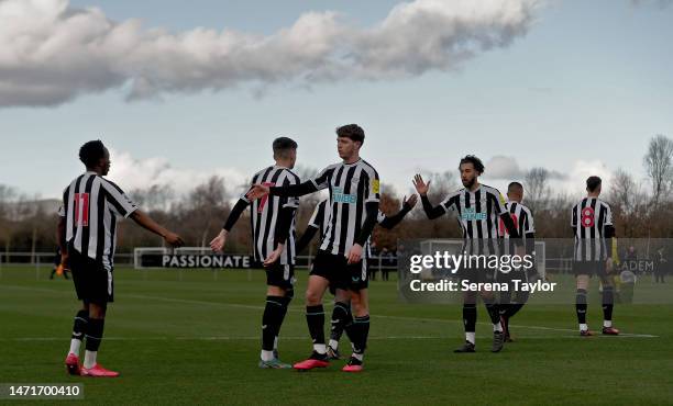 Newcastle players clap hands with Amadou Diallo of Newcastle United after he scores the opening goal during the Premier League 2 match between...