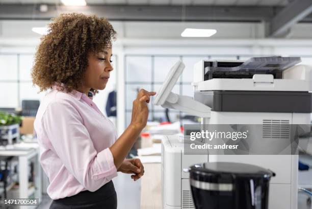 business woman working at the office and copying a document - computer printer stock pictures, royalty-free photos & images