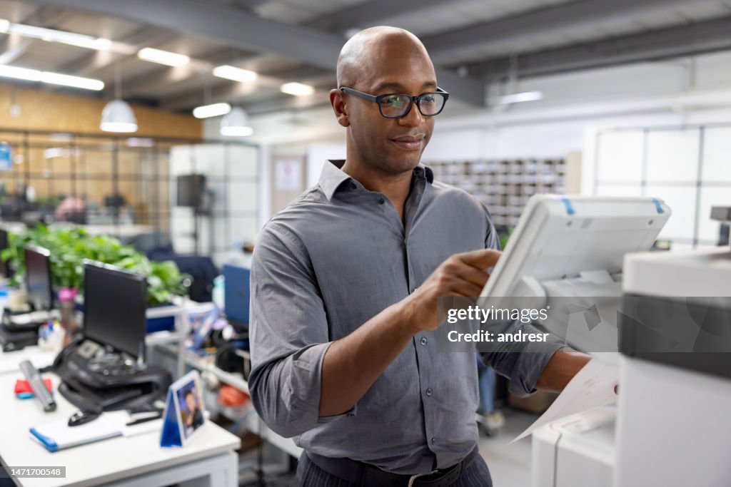 Business man working at the office and making a copy of a document