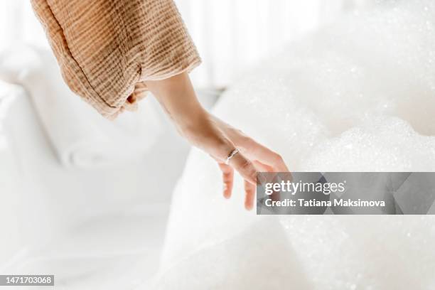 young woman relaxing in bath tub full of foam bubbles. self care and mental health concept. - instinto imagens e fotografias de stock
