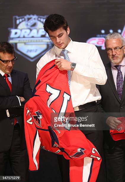Thomas Wilson, 16th overall pick by the Washington Capitals, puts on a jersey during Round One of the 2012 NHL Entry Draft at Consol Energy Center on...