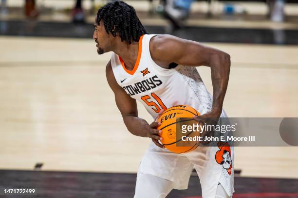 Guard John-Michael Wright of the Oklahoma State Cowboys handles the ball during the second half of the college basketball game against the Texas Tech...