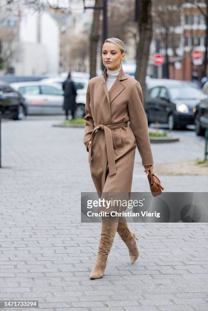 Victoria Magrath wears belted brown coat, bag, wild leather boots outside Akris Paris Fashion Week - Womenswear Fall Winter 2023 2024 : Day Seven on...