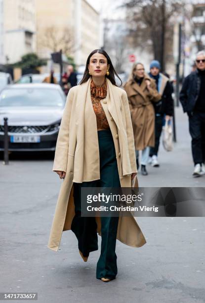 Julia Haghjoo wears beige coat, green pants outside Akris Paris Fashion Week - Womenswear Fall Winter 2023 2024 : Day Seven on March 05, 2023 in...