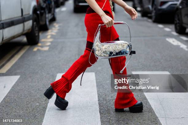 Guest wears silver bag, red pants outside Ottolinger Paris Fashion Week - Womenswear Fall Winter 2023 2024 : Day Seven on March 05, 2023 in Paris,...