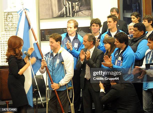 Argentine president Cristina Fernandez de Kirchner greets paralympic swimmer Guillermo Marro during the reception of the Argentinean olympic team...