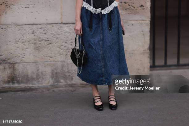 Danielle Marcan seen wearing a complete Vivienne Westwood look with a denim shoulder free corsage, a jeans skirt, black ballet flats and a black...