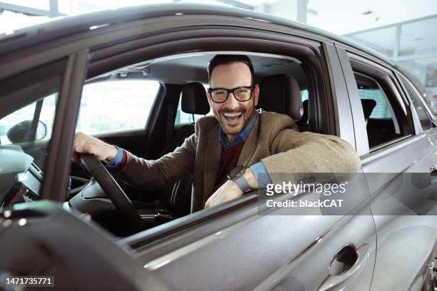 happy male customer inside new car - customer test drive stock pictures, royalty-free photos & images