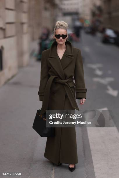 Victoria Magrath seen wearing a black Hermes birkin bag, black shades, a long dark green coat, black leather pants and matching black high heels...
