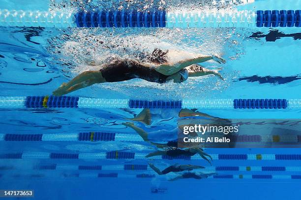 Dana Vollmer and Elaine Breeden compete in the championship final heat of the Women's 100 m Butterfly during Day Two of the 2012 U.S. Olympic...