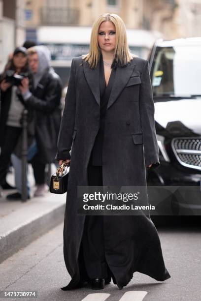 Avril Lavigne wears a dark grey long coat and black bag, outside Lanvin, during Paris Fashion Week - Womenswear Fall Winter 2023 2024, on March 05,...
