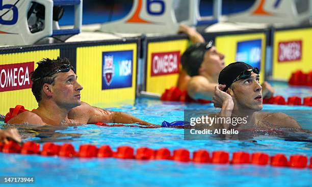 Ryan Lochte and Michael Phelps look on after they competed in the second semifinal heat of the Men's 200 m Freestyle during Day Two of the 2012 U.S....