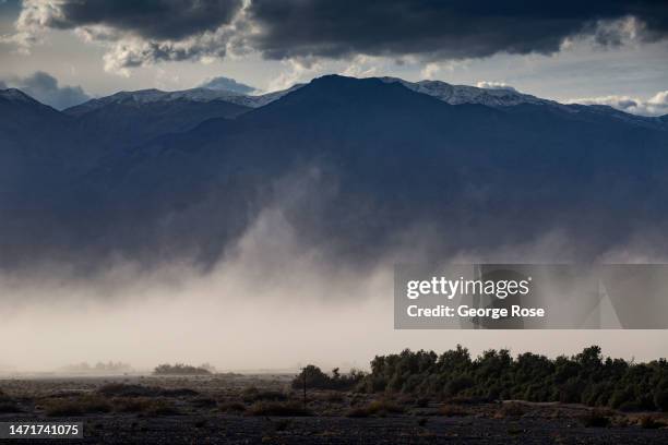 Sandstorm driven by 60 mph winds kicks sand and dust into the air along a dry lake bed on February 28 near Furnace Creek, California. Death Valley...