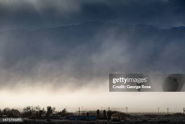 Sandstorm driven by 60 mph winds kicks sand and dust into the air along a dry lake bed on February 28 near Furnace Creek, California. Death Valley...