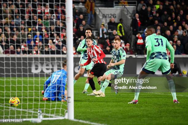 Mathias Jensen of Brentford scores the team's third goal past Bernd Leno of Fulham during the Premier League match between Brentford FC and Fulham FC...