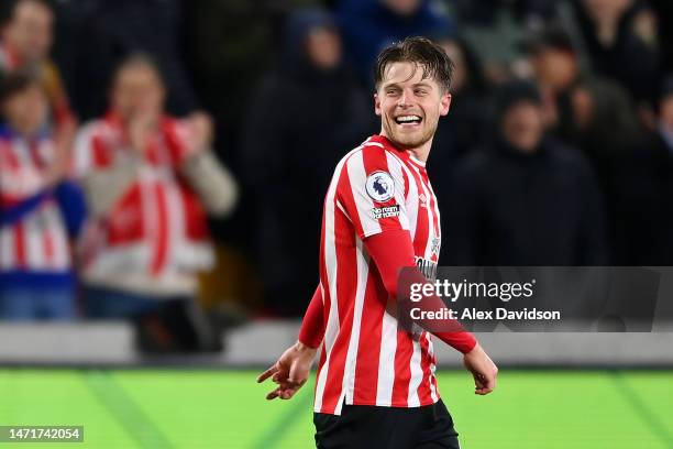 Mathias Jensen of Brentford celebrates after scoring the team's third goal during the Premier League match between Brentford FC and Fulham FC at...