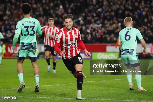 Mathias Jensen of Brentford celebrates after scoring his side's third goal during the Premier League match between Brentford FC and Fulham FC at...