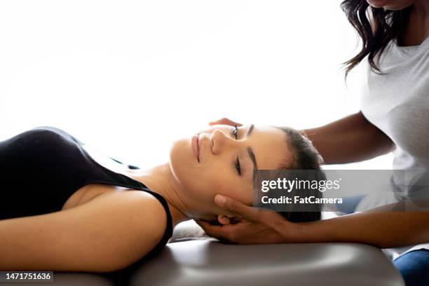 neck adjustment at the chiropractor - chiropractic stock pictures, royalty-free photos & images