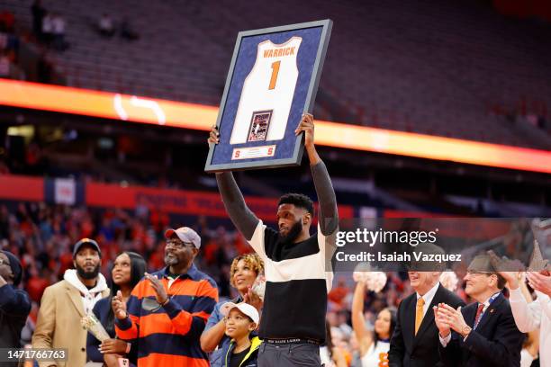 Hakim Warrick holds up his jersey during the 20th anniversary celebration of the 2003 national championship at JMA Wireless Dome on March 4, 2023 in...