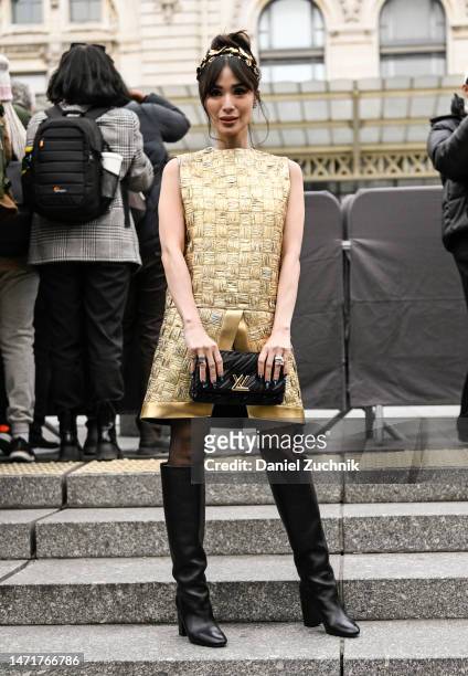 Heart Evangelists is seen wearing a gold Louis Vuitton top and skirt, black knee high boots, Louis Vuitton bag and gold head piece outside the Louis...