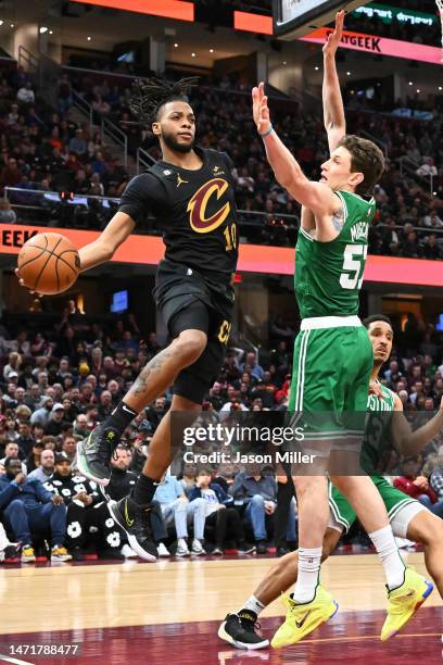 Darius Garland of the Cleveland Cavaliers passes around Mike Muscala of the Boston Celtics during the fourth quarter at Rocket Mortgage Fieldhouse on...