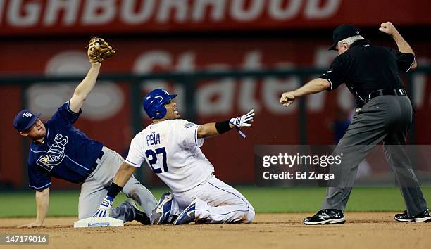 Brian Gorman second base umpire makes the call as Brayan Pena of the Kansas City Royals is tagged out by Brooks Conrad of the Tampa Bay Rays as he...