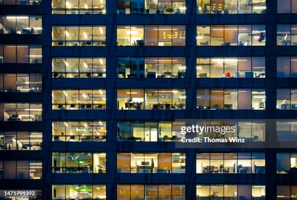 facade of an office building at night - on the outside looking in stock pictures, royalty-free photos & images