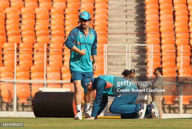 Travis Head and Steve Smith of Australia inspect the pitch during an Australia Test squad training session at Narendra Modi Stadium on March 07, 2023...